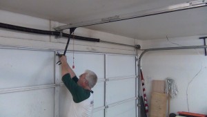 Garage technician repairing garage door in Highland Park Tx